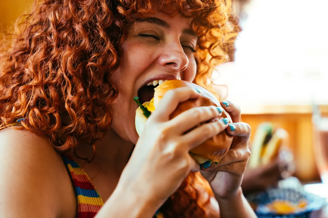 woman-enjoying-delicious-burger-with-closed-eyes-2026-03-24-04-07-00-utc-1280x854.webp